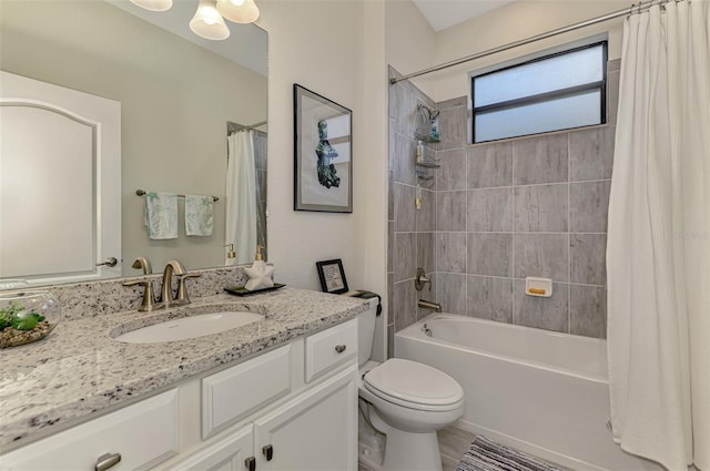 full bath featuring toilet, vanity, and shower / tub combo with curtain