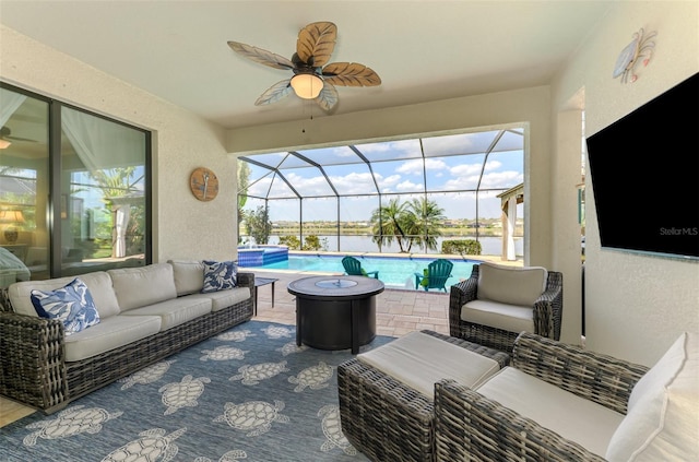 view of patio with a lanai, ceiling fan, a pool with connected hot tub, and an outdoor living space