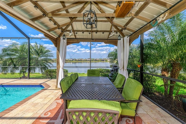 unfurnished sunroom featuring a water view and vaulted ceiling