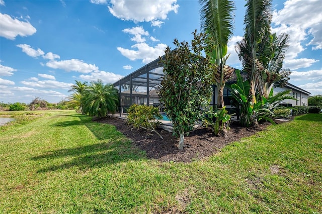 view of yard featuring a pool and a lanai