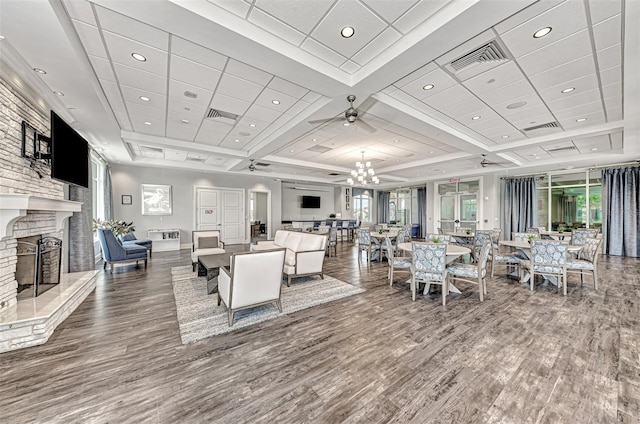 interior space featuring visible vents, a fireplace with raised hearth, and wood finished floors