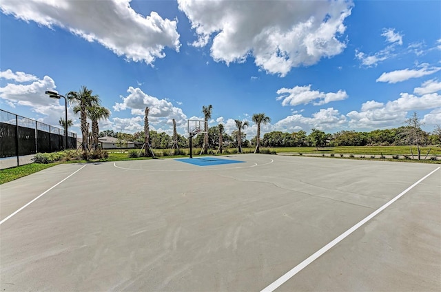 view of basketball court with community basketball court and fence