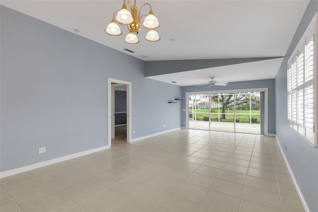 spare room featuring plenty of natural light, light tile patterned flooring, lofted ceiling, and baseboards