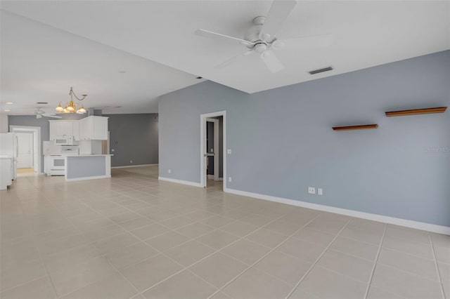 unfurnished living room with light tile patterned floors, visible vents, baseboards, and ceiling fan with notable chandelier