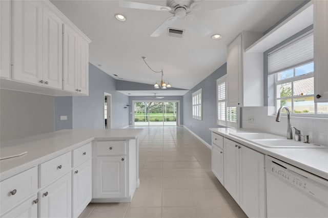 kitchen with light countertops, visible vents, white cabinets, white dishwasher, and a sink