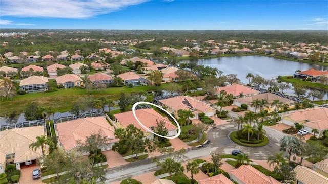 drone / aerial view with a water view and a residential view