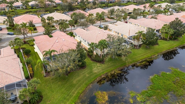 birds eye view of property featuring a water view and a residential view