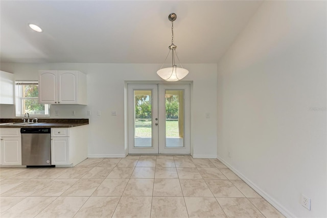 kitchen with a sink, white cabinetry, french doors, stainless steel dishwasher, and dark countertops