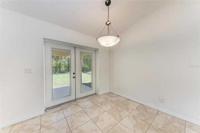 interior space with light tile patterned floors, baseboards, and french doors