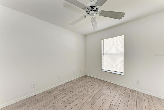 spare room featuring light wood-style floors, ceiling fan, and baseboards