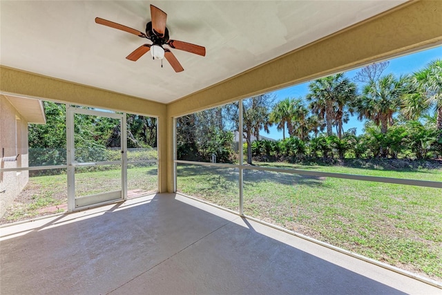 unfurnished sunroom with a ceiling fan