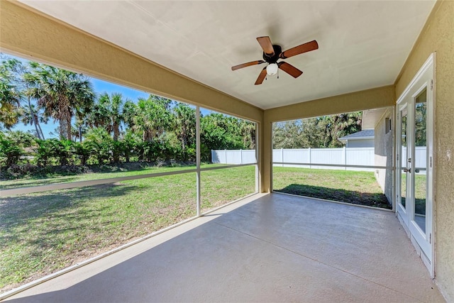 unfurnished sunroom with a wealth of natural light and a ceiling fan