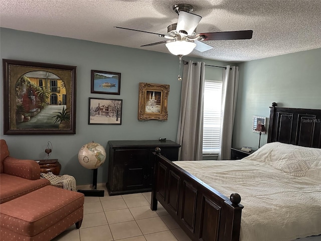 1805 Springwood Dr, Sarasota, FL 34232 - bedroom featuring light tile patterned floors, a textured ceiling, ceiling fan, and baseboards