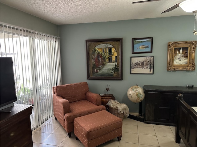 1805 Springwood Dr, Sarasota, FL 34232 - living area featuring plenty of natural light, light tile patterned floors, ceiling fan, and a textured ceiling