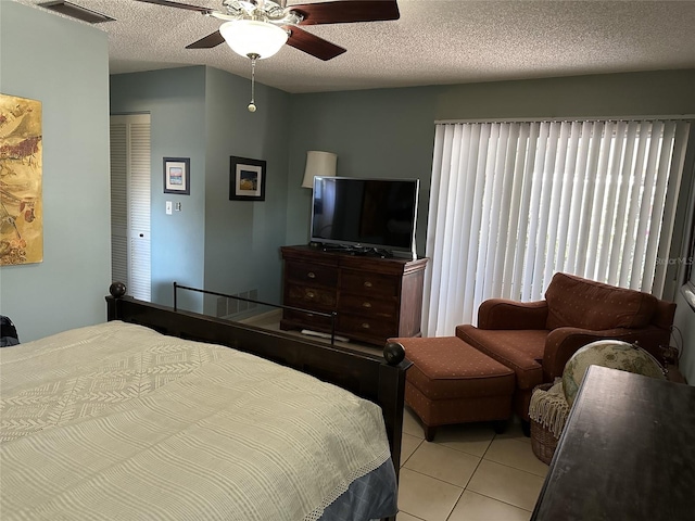 1805 Springwood Dr, Sarasota, FL 34232 - bedroom with light tile patterned flooring, a textured ceiling, and ceiling fan