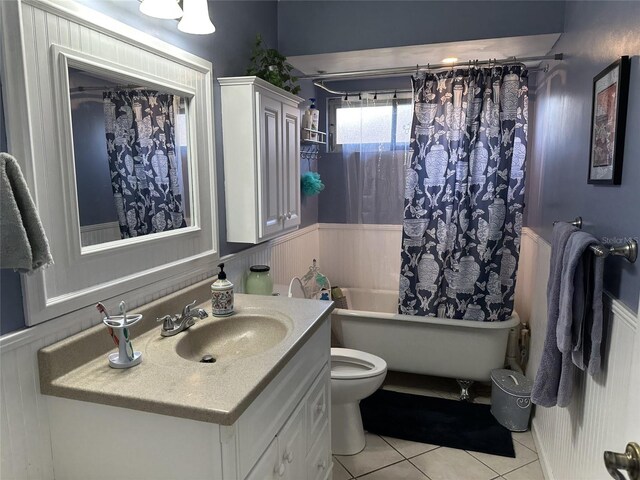 1805 Springwood Dr, Sarasota, FL 34232 - full bathroom featuring a wainscoted wall, tile patterned flooring, vanity, shower / bath combo, and toilet