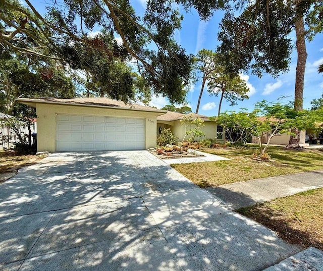 1805 Springwood Dr, Sarasota, FL 34232 - single story home with stucco siding, concrete driveway, an attached garage, and a front yard