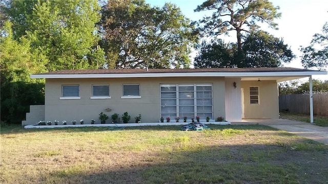 view of front of house with a front yard and fence