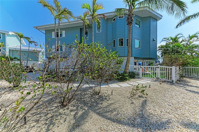 rear view of house with a gate and fence