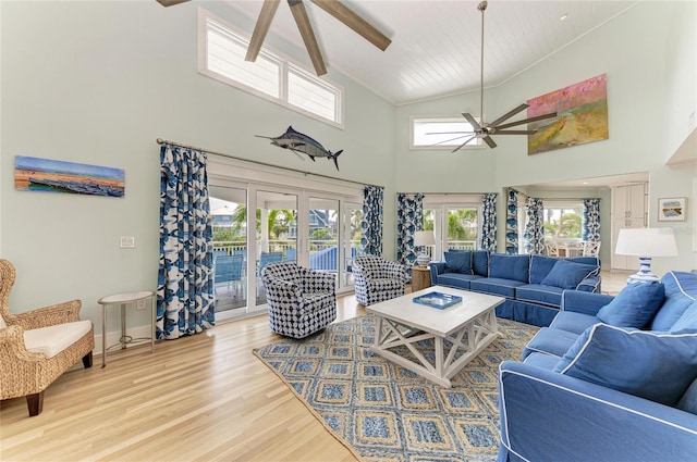 living room with french doors, lofted ceiling, a ceiling fan, light wood-type flooring, and baseboards