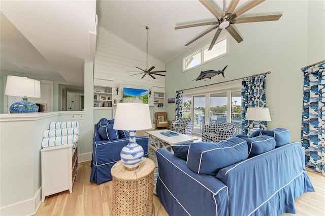 living room with light wood-style floors, ceiling fan, and high vaulted ceiling