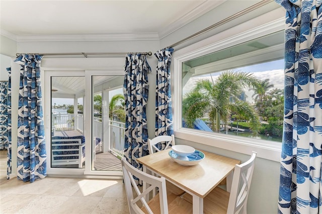 dining space with ornamental molding