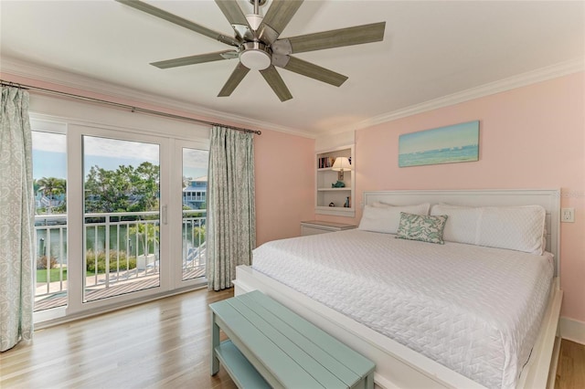 bedroom featuring crown molding, multiple windows, wood finished floors, and access to exterior