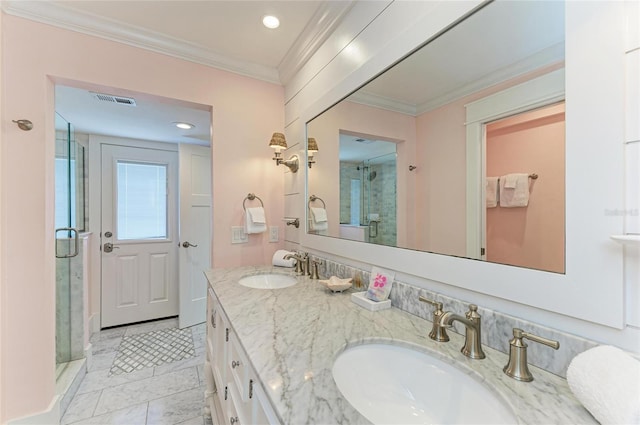 bathroom with a stall shower, visible vents, a sink, and ornamental molding