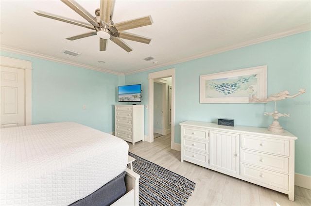 bedroom featuring light wood finished floors, ceiling fan, ornamental molding, and visible vents