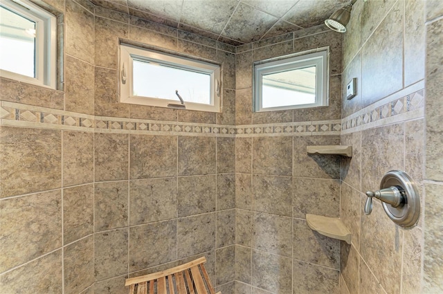 bathroom featuring plenty of natural light and a tile shower