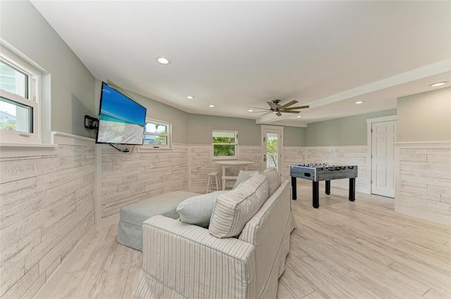 interior space featuring a wainscoted wall, recessed lighting, and light wood-style floors