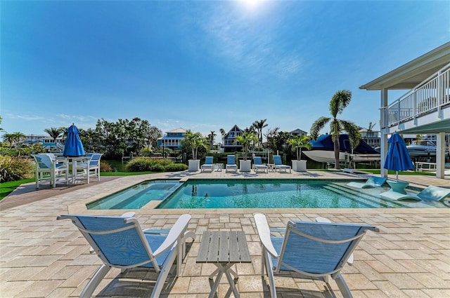 view of pool featuring a pool with connected hot tub and a patio