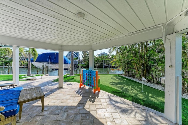 view of patio with a dock, a water view, and boat lift