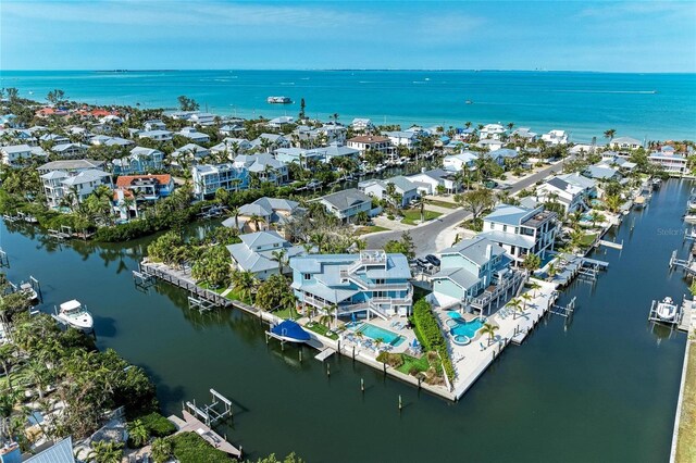 birds eye view of property with a water view and a residential view