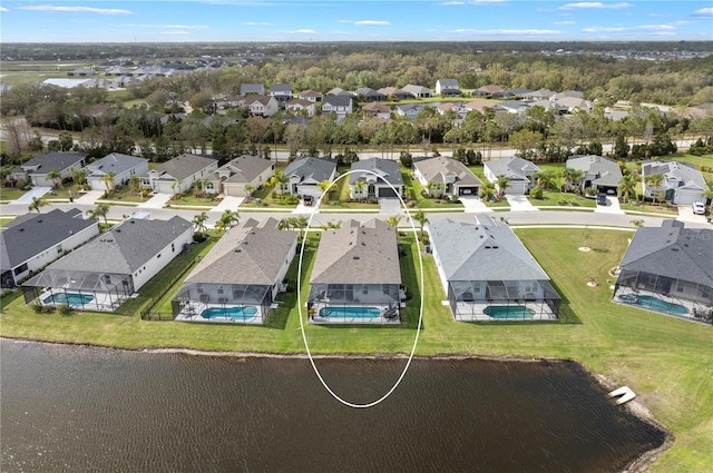 birds eye view of property with a water view and a residential view