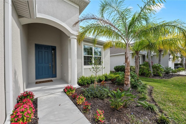 property entrance with stucco siding