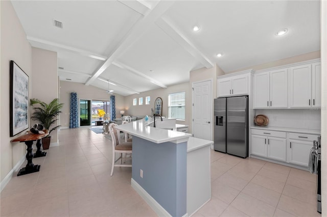 kitchen with visible vents, appliances with stainless steel finishes, open floor plan, vaulted ceiling with beams, and light tile patterned flooring