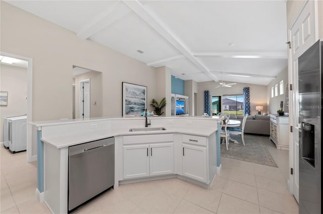 kitchen with appliances with stainless steel finishes, open floor plan, vaulted ceiling with beams, light countertops, and a sink