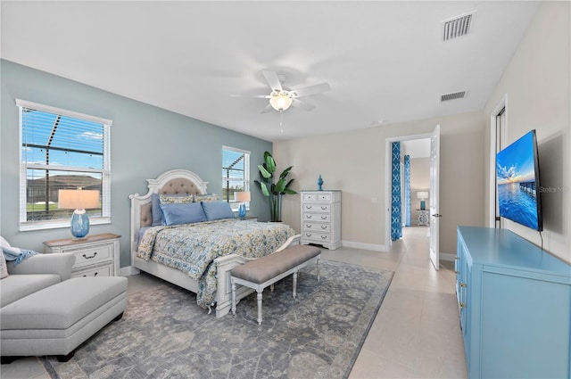 bedroom featuring ceiling fan, light tile patterned floors, visible vents, and baseboards