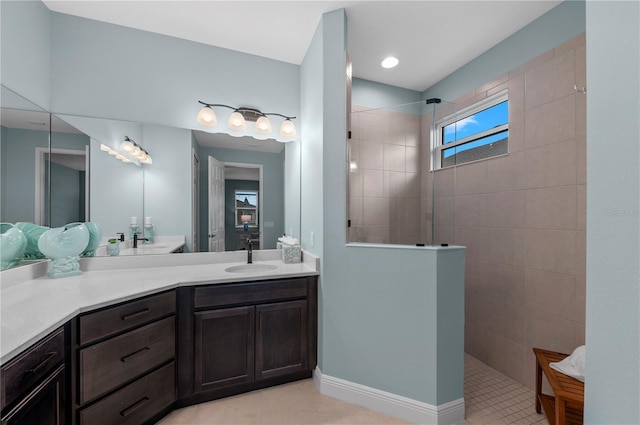 full bathroom featuring walk in shower, vanity, and tile patterned floors