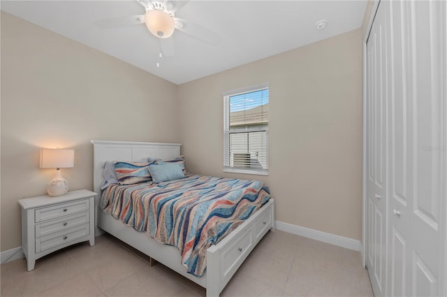 bedroom featuring light tile patterned floors, ceiling fan, and baseboards