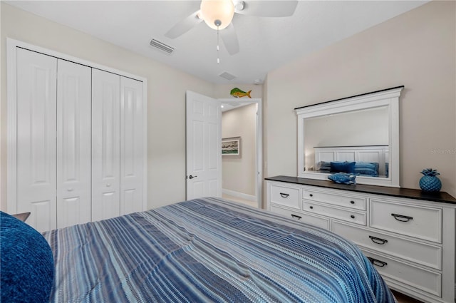 bedroom with a closet, visible vents, and ceiling fan