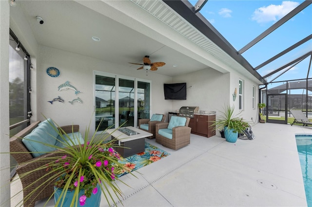 view of patio / terrace with ceiling fan, exterior kitchen, a lanai, an outdoor pool, and a fire pit