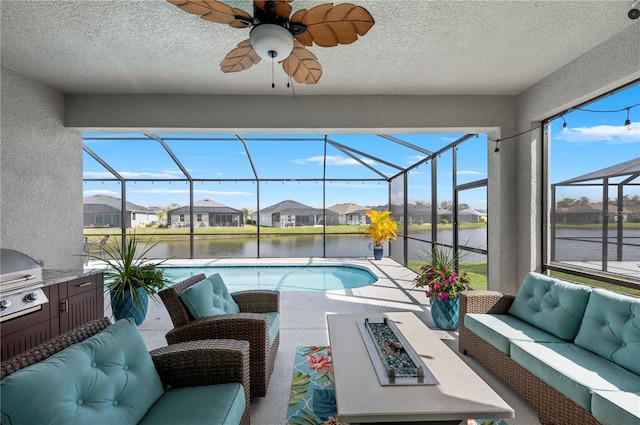 interior space with a ceiling fan, a residential view, a water view, and area for grilling