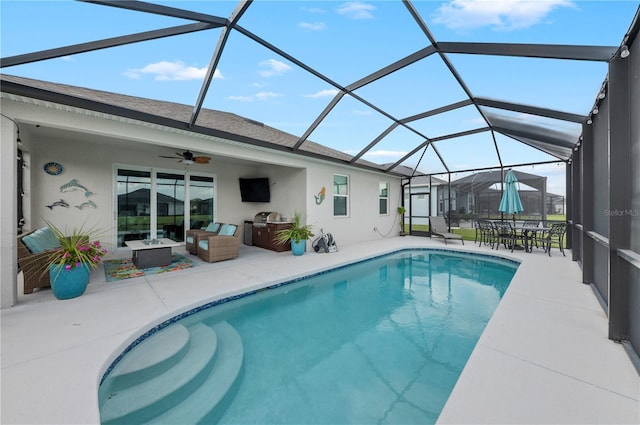 pool featuring a lanai, a patio area, and a ceiling fan