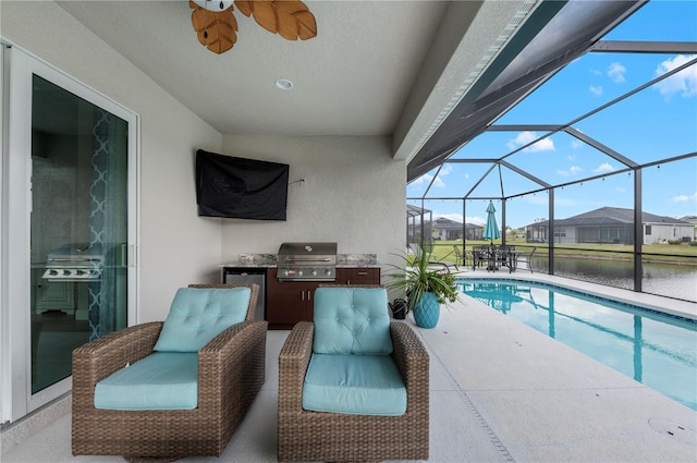 outdoor pool featuring an outdoor kitchen, area for grilling, glass enclosure, a patio area, and ceiling fan