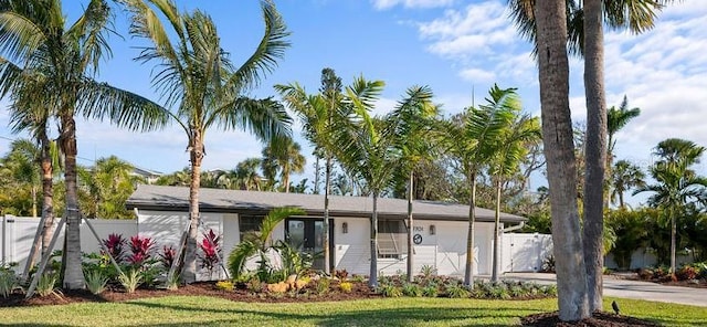 ranch-style home with concrete driveway, fence, and a garage