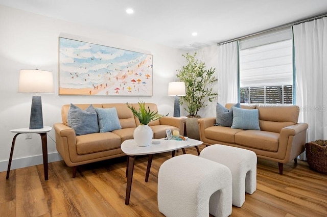 living area with recessed lighting, wood finished floors, and baseboards