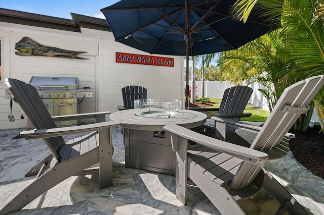 view of patio with a grill and fence