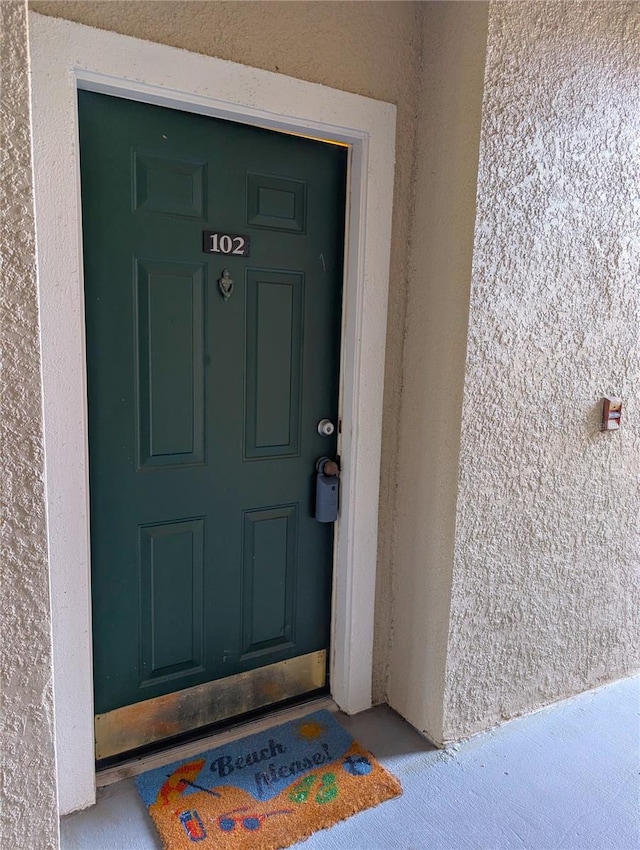 doorway to property with stucco siding